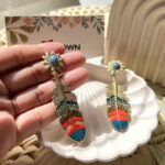 Gold feather drop earrings with enamel detail and rhinestones – Boho Feather Earrings by Uptown Accessories
