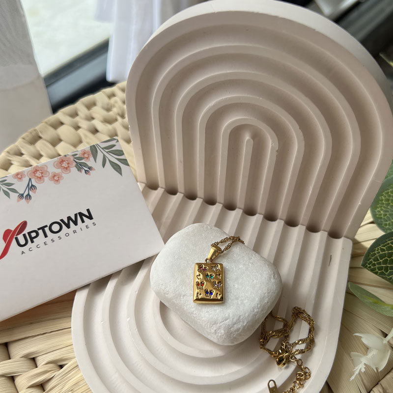 Gold rectangular pendant with floral gemstone detail on rope chain – Meadow Bloom Necklace by Uptown Accessories