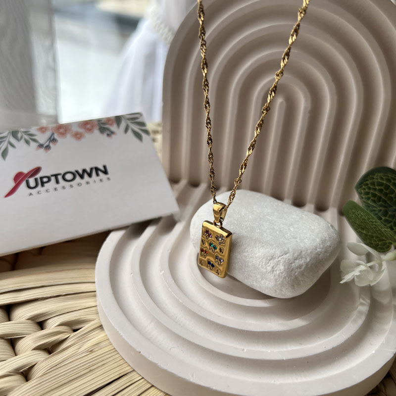 Gold rectangular pendant with floral gemstone detail on rope chain – Meadow Bloom Necklace by Uptown Accessories
